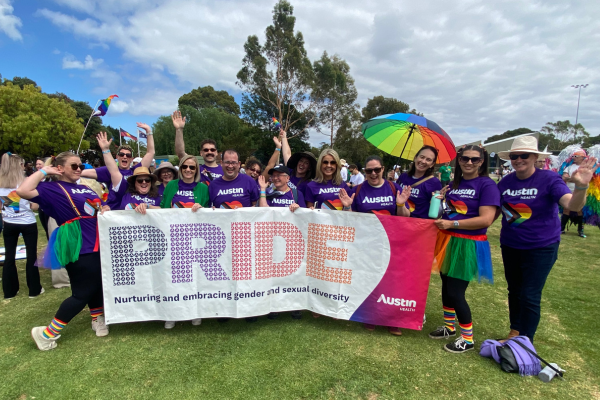 Staff at Midsumma Pride March with a PRIDE banner